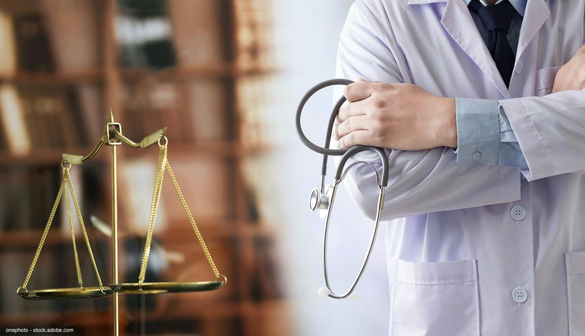 set of scales next a doctor with their arms folded, holding a stethoscope