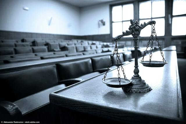 Scales of justice in courtroom | Image Credit: ©  Aleksandar Radovanov - stock.adobe.com